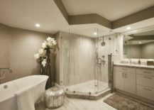 Bathroom with white tub and glass shower.