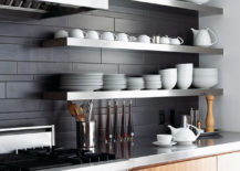 Charcoal ceramic tiles, walnut cabinetry and stainless steel shelves are a winning trio in this stylish kitchen.