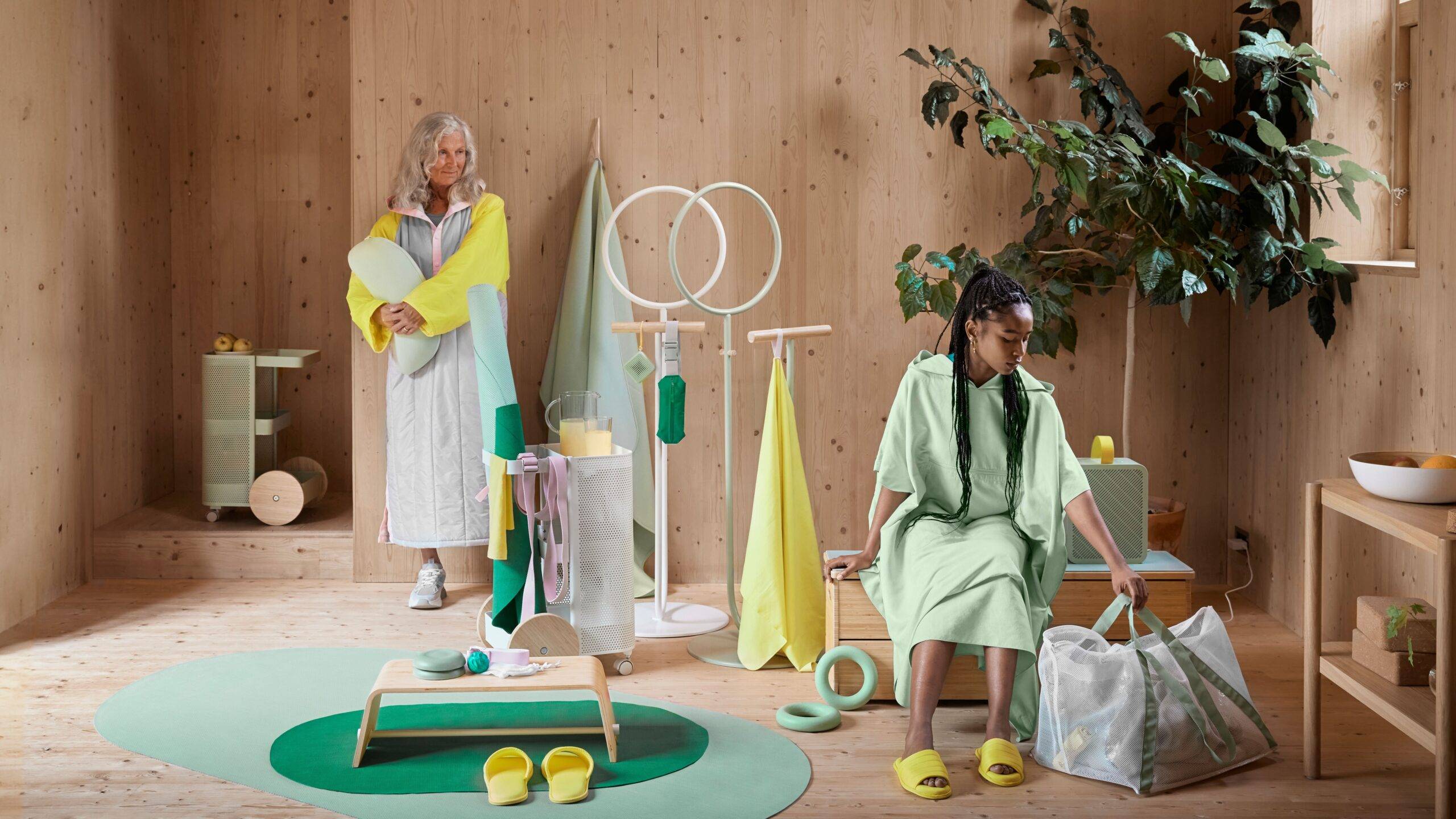 Image of workout gear from the DAJLIEN Collection by IKEA and two women.