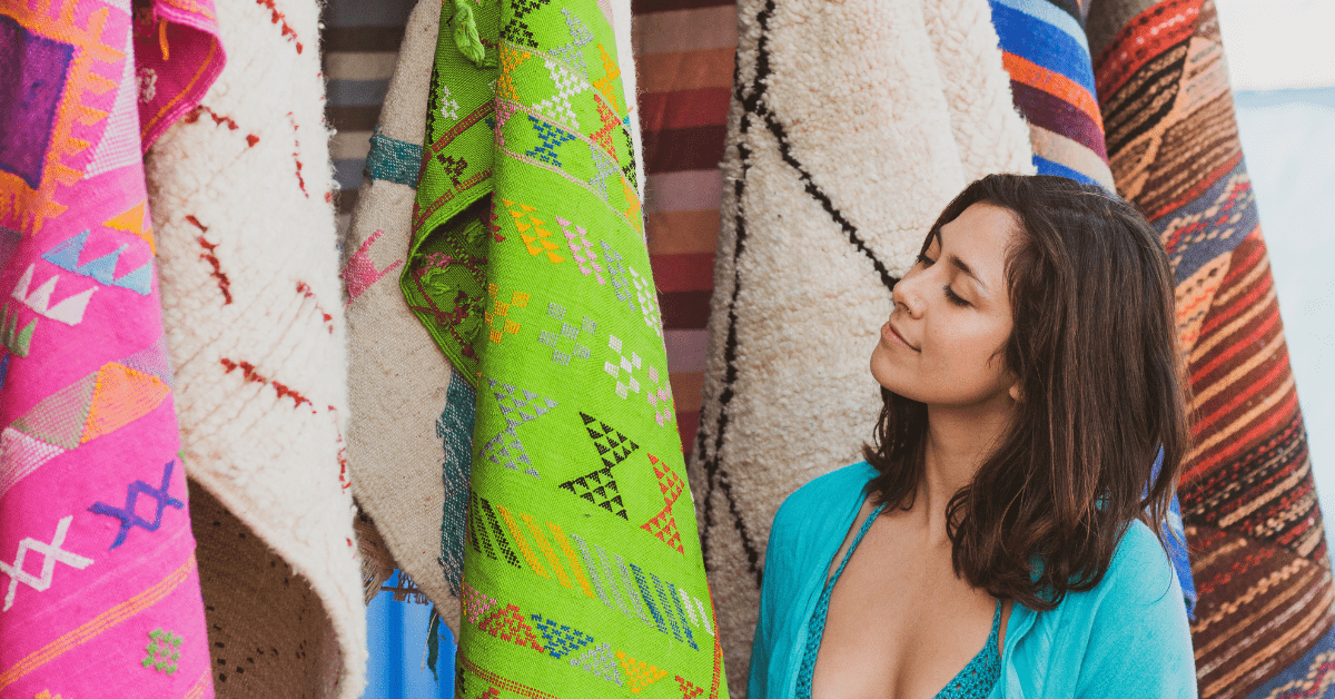 Woman choosing a rug from a store.