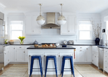 The kitchen of a Bungalow house, showcasing a modern renovated white kitchen.