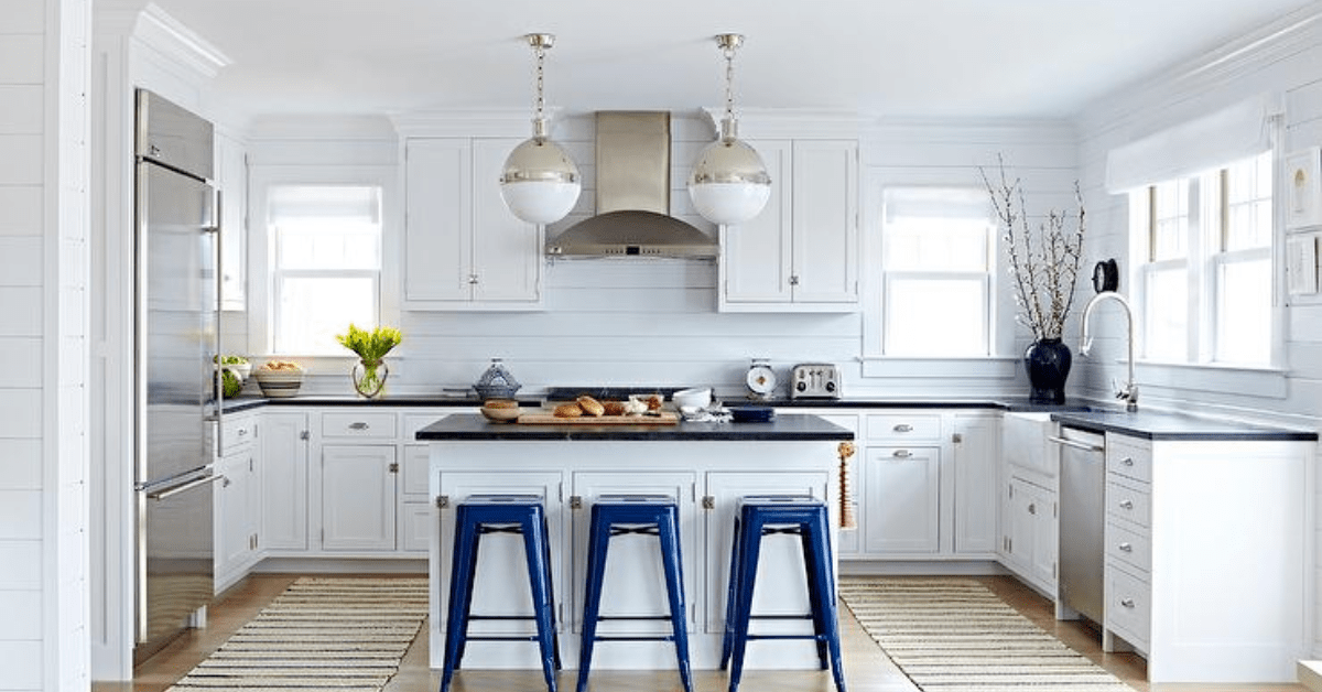 The kitchen of a Bungalow house, showcasing a modern renovated white kitchen.