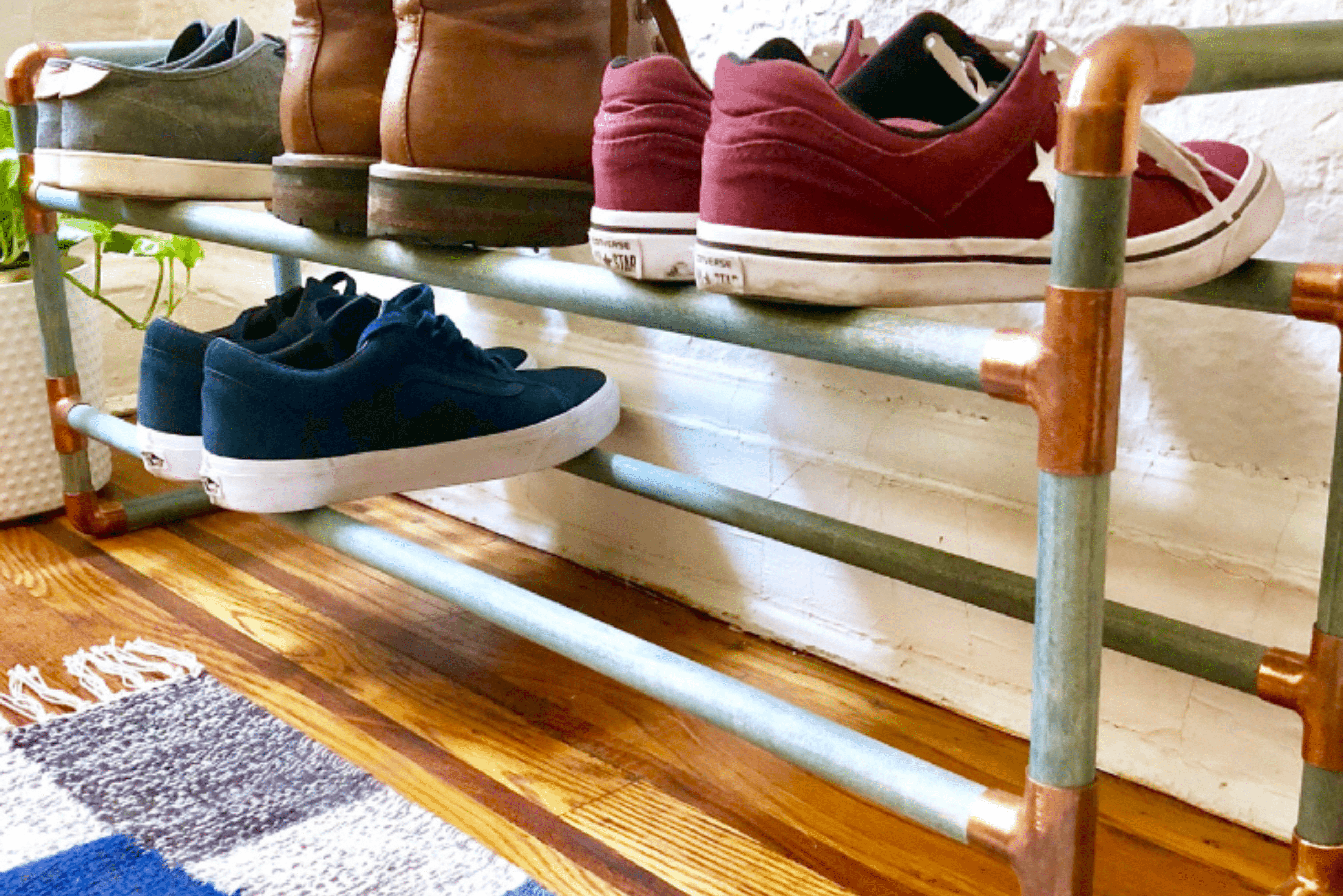 Metal DIY shoe rack with copper joints.
