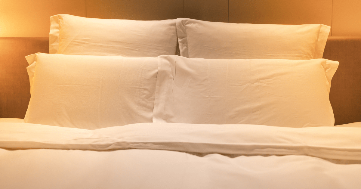 Bed with white pillows and sheets.
