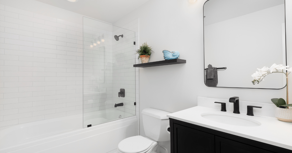 White themed bathroom with white subway tile shower.