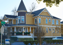 A Victorian style house with yellow painted exterior walls.